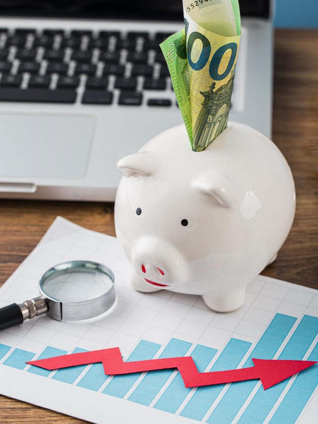 cropped-high-angle-office-items-with-piggy-bank-growth-chart-1.jpg
